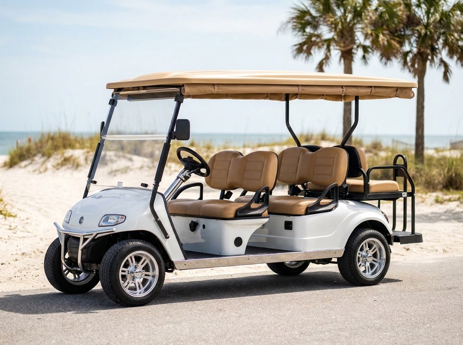 Six-seat white and tan golf cart on a beachside road
